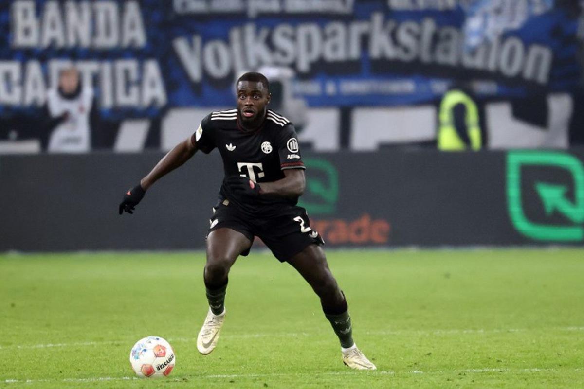Bayern Munich's French defender #02 Dayot Upamecano runs with the ball during the German first division Bundesliga football match between Hamburger SV and FC Bayern Munich in Hamburg, northern Germany on January 31, 2026.  IBRAHIM OT / AFP
