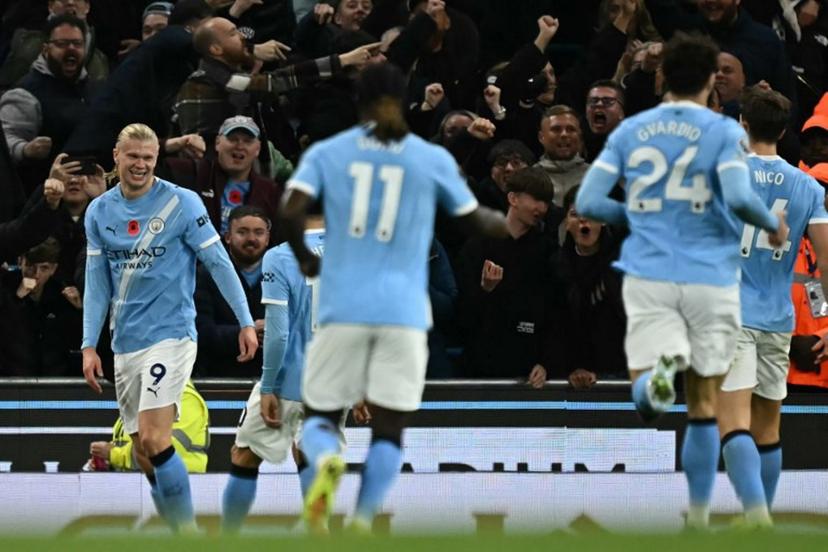 Manchester City's Norwegian striker #09 Erling Haaland (L) celebrates after scoring their second goal during the English Premier League football match between Manchester City and Bournemouth at the Etihad Stadium in Manchester, north west England, on November 2, 2025.  Paul ELLIS / AFP
