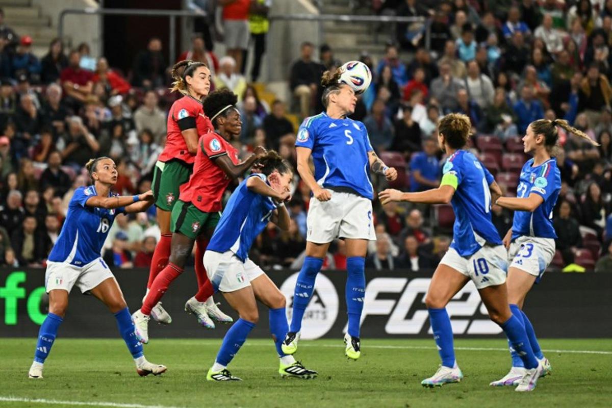 Italy's defender #05 Elena Linari (C) heads the ball during the UEFA Women's Euro 2025 Group B football match between Portugal and Italy at the Stade de Geneve in Geneva, on July 7, 2025.  Fabrice COFFRINI / AFP