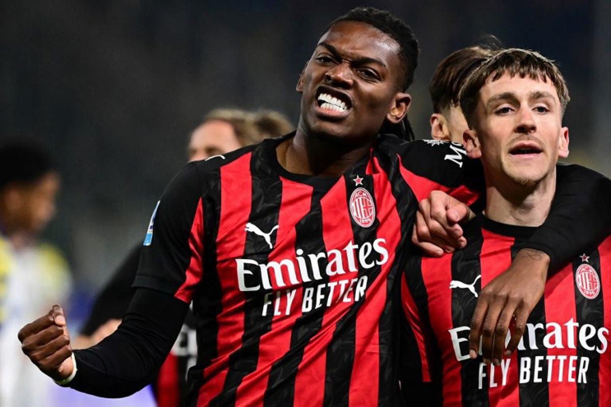 AC Milan's Belgian midfielder #56 Alexis Saelemaekers (R) celebrates with AC Milan's Portuguese forward #10 Rafael Leao after scoring his team first goal during the Italian Serie A football match between Parma and AC Milan at the San Siro Stadium in Parma, northern Italy, on November 8, 2025.  Piero CRUCIATTI / AFP