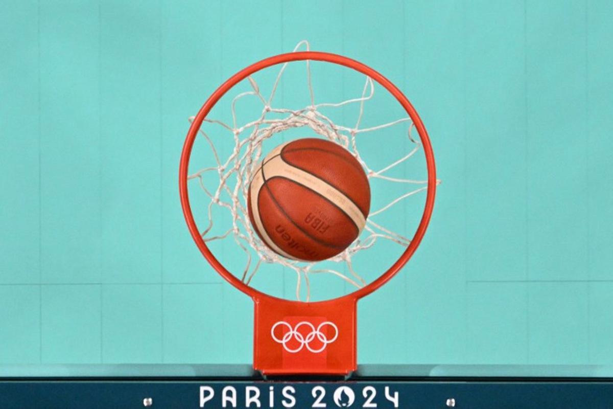 An overview shows the ball enter the basket in the women's preliminary round group A basketball match between Serbia and Puerto Rico during the Paris 2024 Olympic Games at the Pierre-Mauroy stadium in Villeneuve-d'Ascq, northern France, on July 28, 2024.  Sameer Al-DOUMY / POOL / AFP