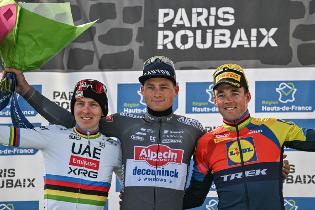 Second placed UAE Team Emirate's Slovenian rider Tadej Pogacar (L), First placed Alpecin-Deceuninck's Dutch rider Mathieu van der Poel and Third placed Lidl-Trek's Danish rider Mads Pedersen celebrate on the podium of the 122nd edition of the Paris-Roubaix one-day classic cycling race, 259,2 km between Compiegne and Roubaix, northern France on April 13, 2025.  Jeff PACHOUD / AFP