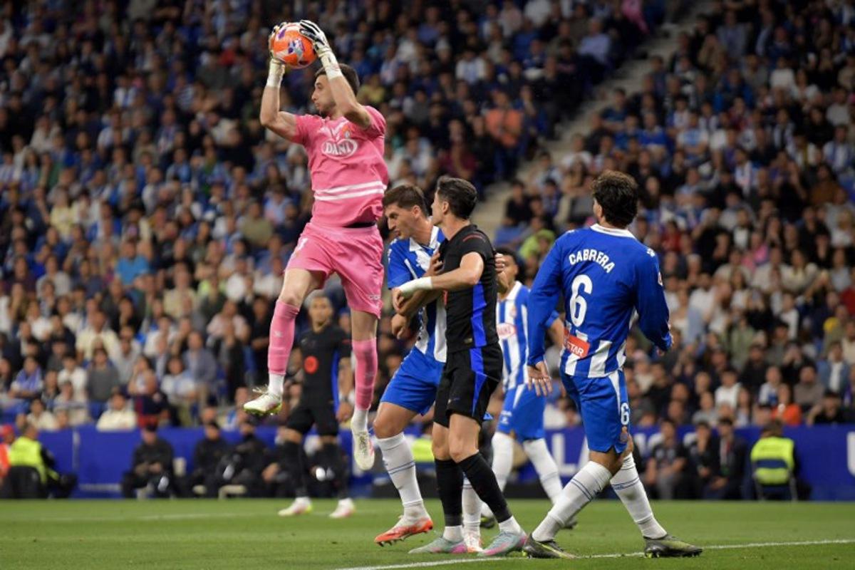 Espanyol's Spanish goalkeeper #01 Joan Garcia catches the ball during the Spanish league football match between RCD Espanyol and FC Barcelona at the RCDE Stadium in Cornella de Llobregat, on May 15, 2025.  MANAURE QUINTERO / AFP