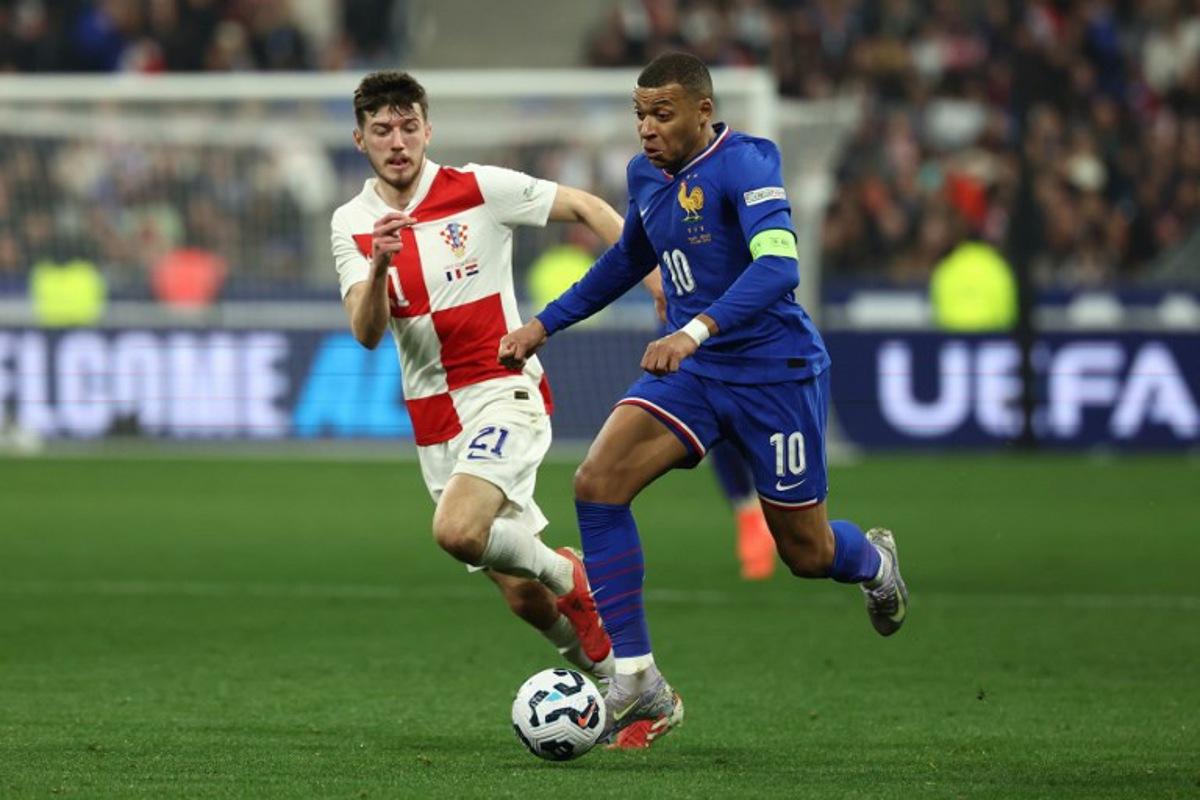 France's forward #10 Kylian Mbappe (R) and Croatia's midfielder #21 Petar Sucic (L) fight for the ball during the UEFA Nations League quarter-final second-leg football match between France and Croatia at the Stade de France in Saint-Denis, north of Paris, on March 23, 2025.  FRANCK FIFE / AFP