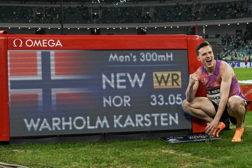 Norway's Karsten Warholm poses with his time of 33.05 seconds after he broke the men's 300m hurdles world record during the Xiamen IAAF Diamond League athletics meeting at Egret Stadium in Xiamen, in China's eastern Fujian province, on April 26, 2025.  ADEK BERRY / AFP