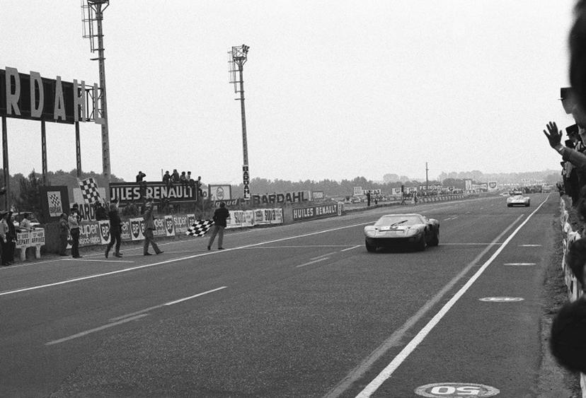 The John Wyer Automotive Engineering team Ford GT 40 N°6 of drivers Belgian Jacky Ickx and British Jackie Oliver crosses the finish line, winning the 37th edition of the 24 hours of Le Mans on June 15, 1969 on the circuit de la Sarthe in Le Mans, western France. The 37th edition of the 24 Hours of Le Mans remained famous for its close finish between the Ford GT40 of Jacky Ickx and Jackie Oliver and the Porsche 908 of Hans Hermann and Gérard Larrousse, with the first of six victories for Jacky Ickx and the fourth Ford's consecutive win. Jacky Ickx, to mark his disagreement with the Type Le Mans start, crosses the track walking. This start will be abandoned in 1971 in favor of the rolling start. AFP