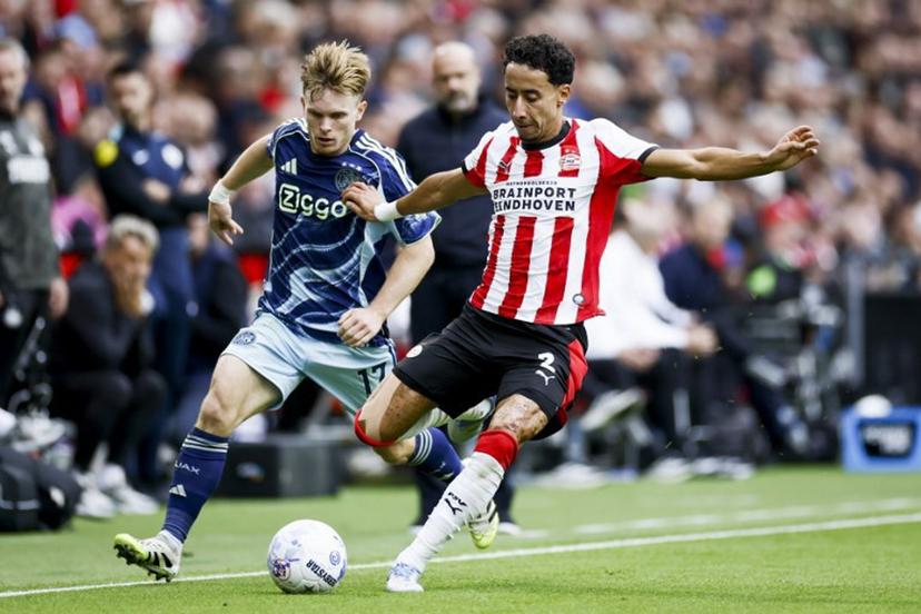 Ajax's Norwegian forward #17 Oliver Edvardsen and PSV Eindhoven Netherland's defender #02 Anass Salah-Eddine of fight for the ball during the Dutch Eredivisie football match between PSV Eindhoven and Ajax at the Phillips Stadium, in Eindhoven, on September 21, 2025.  Koen van Weel / ANP / AFP
