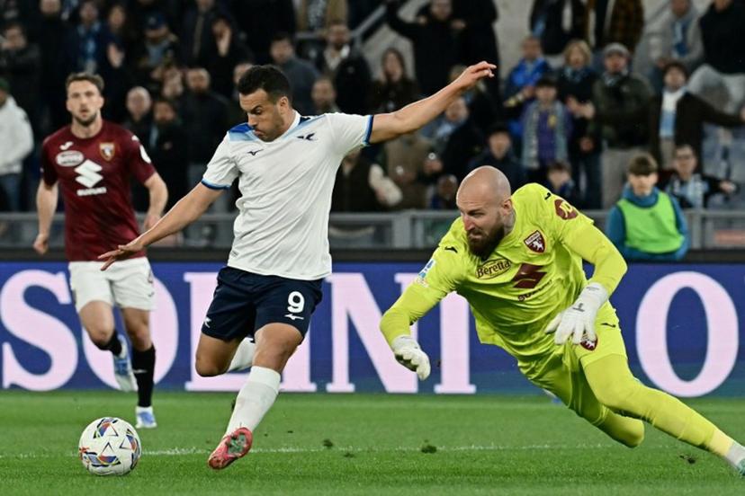 Lazio's Spanish forward #09 Pedro Rodriguez (L) shoots towards goal as Torino's Serbian goalkeeper #32 Vanja Milinkovic-Savic (R) dives to block it during the Italian Serie A football match between Lazio and Torino at the Olympic Stadium in Rome on March 31, 2025.  Filippo MONTEFORTE / AFP