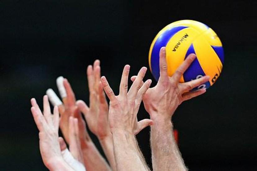 Poland players jump to block the ball during the men's qualifying volleyball match between Poland and Iran at the Maracanazinho stadium in Rio de Janeiro on August 9, 2016, during the Rio 2016 Olympic Games. 
Johannes EISELE / AFP