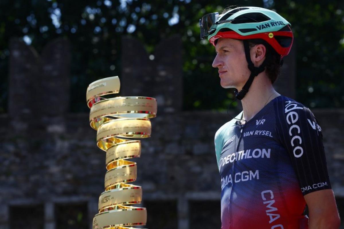 Decathlon CMA CGM Team Austrian rider Felix Gall looks on near the Giro d'Italia trophy ("trofeo senza fine") during the presentation prior the 16th stage of the Giro d'Italia 2026 - Tour of Italy cycling race between Bellinzona and Cari, Switzerland, on May 26, 2026.  Luca Bettini / AFP