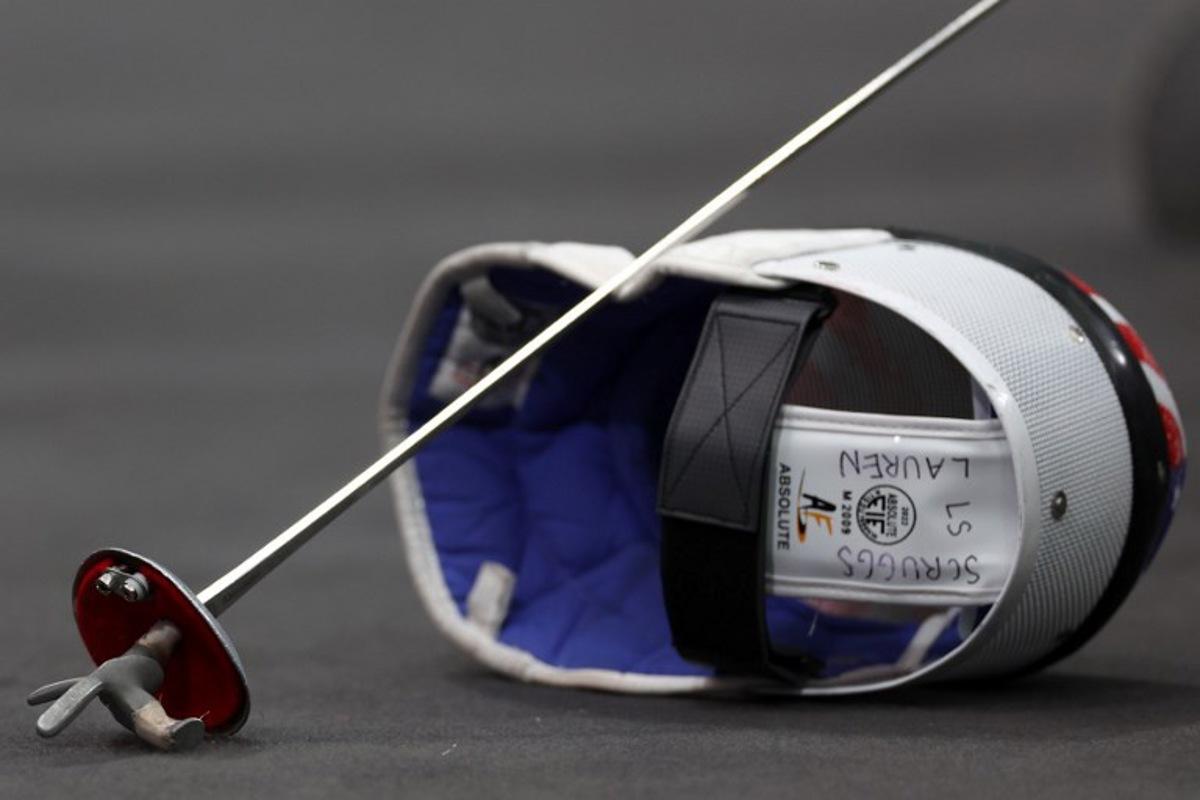 The helmet and sword of US' Lauren Scruggs are seen as she competes Canada in the women's foil team semi-final bout between Canada and USA during the Paris 2024 Olympic Games at the Grand Palais in Paris, on August 1, 2024.  Franck FIFE / AFP