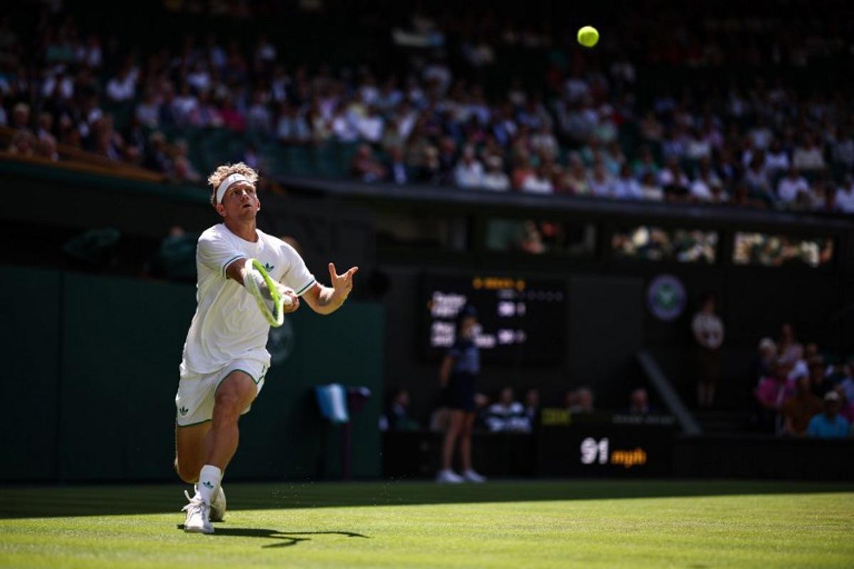 Spain's Alejandro Davidovich Fokina plays a forehand return to US player Taylor Fritz  during their men's singles third round tennis match on the fifth day of the 2025 Wimbledon Championships at The All England Lawn Tennis and Croquet Club in Wimbledon, southwest London, on July 4, 2025.  HENRY NICHOLLS / AFP