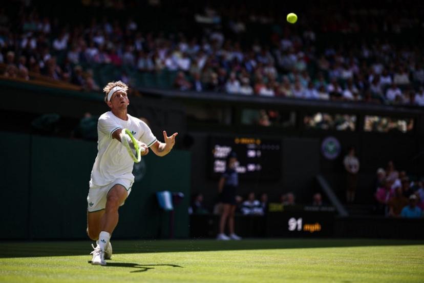 Spain's Alejandro Davidovich Fokina plays a forehand return to US player Taylor Fritz  during their men's singles third round tennis match on the fifth day of the 2025 Wimbledon Championships at The All England Lawn Tennis and Croquet Club in Wimbledon, southwest London, on July 4, 2025.  HENRY NICHOLLS / AFP