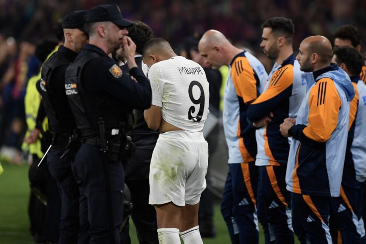 Real Madrid's French forward #09 Kylian Mbappe reacts after the Spanish Cup, Copa del Rey (King's Cup) final football match between FC Barcelona and Real Madrid CF at La Cartuja stadium in Seville on April 26, 2025.  Josep LAGO / AFP