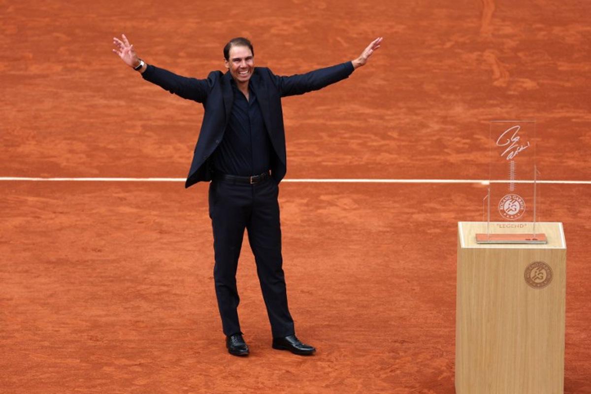 Former Spanish player Rafael Nadal greets the spectators at the end of a ceremony honoring his career on Court Philippe-Chatrier during the French Open tennis tournament at the Roland-Garros Complex in Paris on May 25, 2025. May 23, 2025, marked 20 years since Spain's Raphael Nadal shook Roland Garros with his first match at the French Open, changing the tennis tournament's history forever. Two decades and 14 titles later, the clay court legend, who retired in November 2024, will receive a tribute during the tournament on May 25, 2025. Franck FIFE / AFP