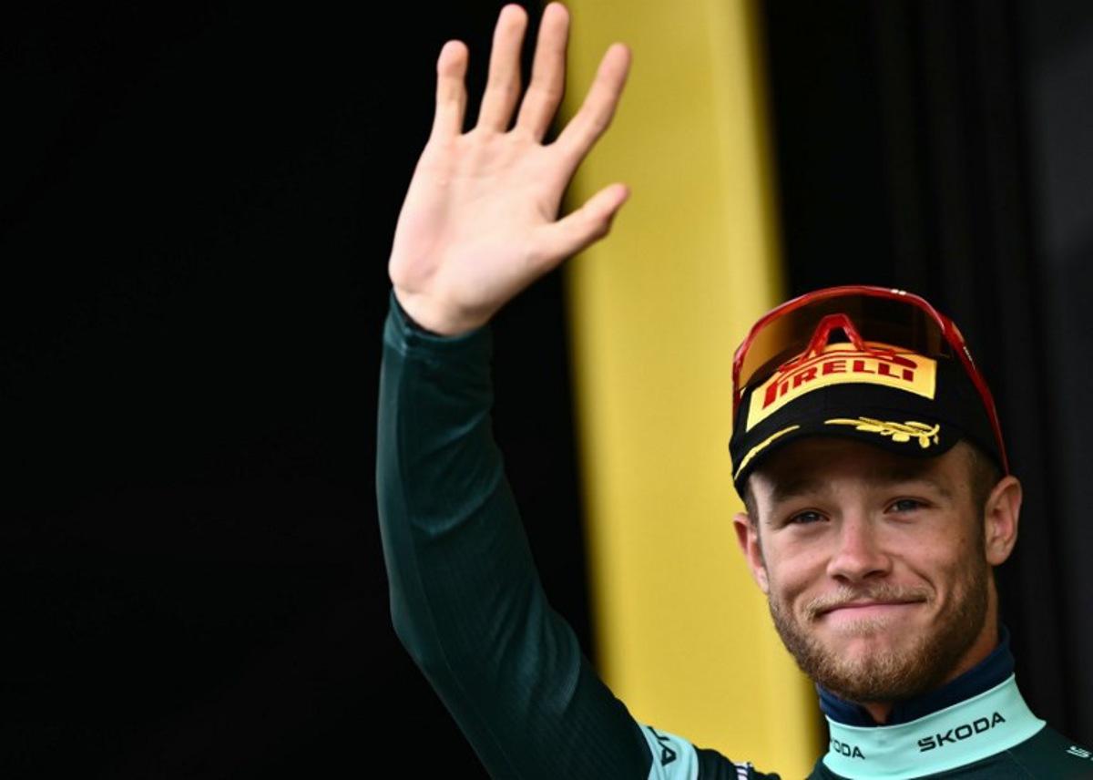 Lidl - Trek team's Italian rider Jonathan Milan celebrates on the podium with the best sprinter's green jersey after the 20th stage of the 112th edition of the Tour de France cycling race, 184.2 km between Nantua and Pontarlier, in the Jura, eastern France, on July 26, 2025.  Marco BERTORELLO / AFP