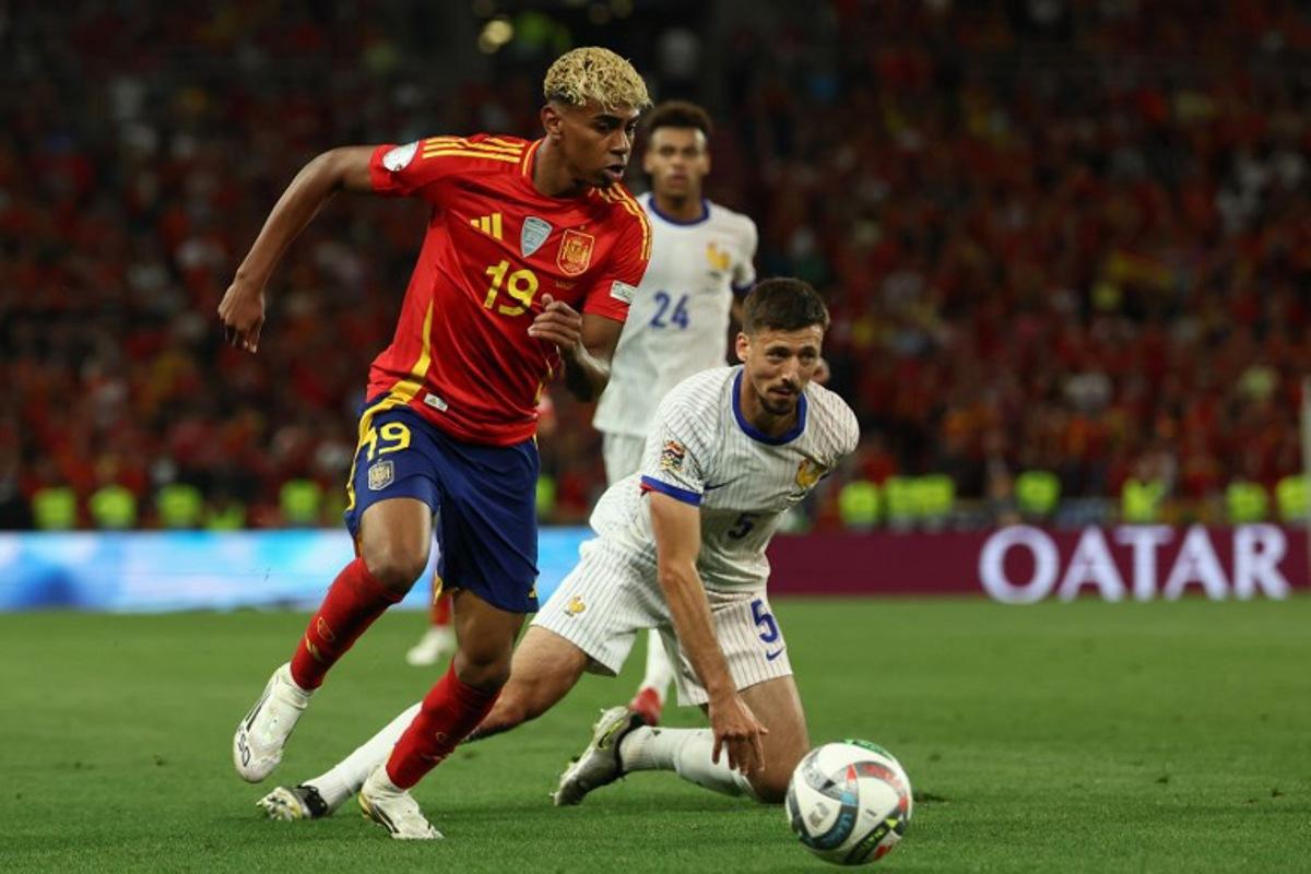 Spain's forward #19 Lamine Yamal (L) and France's defender #05 Clement Lenglet vie for the ball during the UEFA Nations League semi-final football match between Spain and France in Stuttgart, southwestern Germany, on June 5, 2025.  FRANCK FIFE / AFP