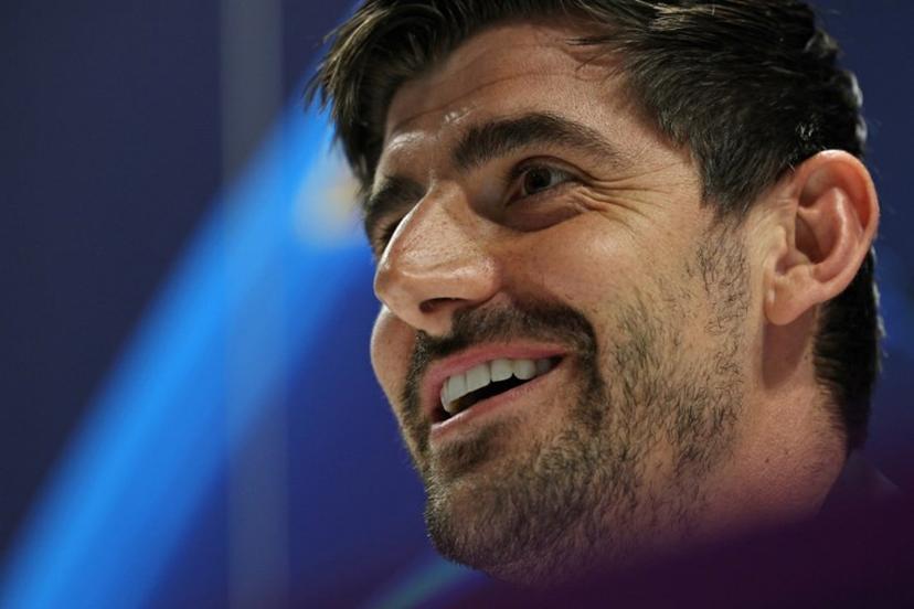 Real Madrid's Belgian goalkeeper #01 Thibaut Courtois smiles during a press conference at the Emirates stadium in London on April 7, 2025, on the eve of their UEFA Champions League Quarter-final first leg football match against Arsenal.  Adrian Dennis / AFP