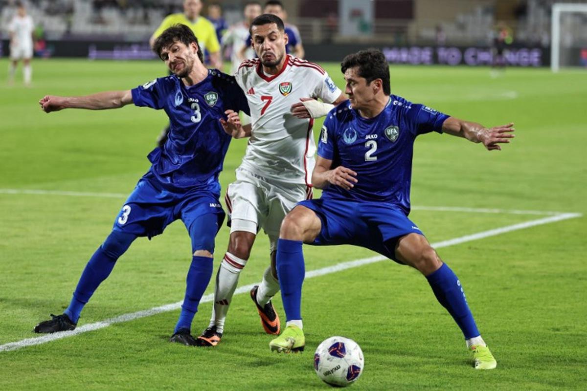 Uzbekistan's defender #3 Khojiakbar Alijonov and defender #2 Abdukodir Khusanov vie for the ball against UAE's forward #7 Ali Saleh during the 2026 FIFA World Cup Asian Qualifier football match between the United Arab Emirates and Uzbekistan at Al-Nahyan Stadium in Abu Dhabi on June 5, 2025.  Fadel SENNA / AFP