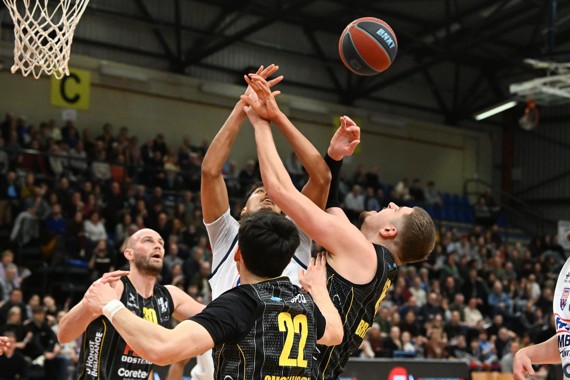 Limburg's Aubin Gateretse, Oostende's Andre Gustavson and Oostende's Haris Bratanovic pictured in action during a basketball match between Limburg United and BC Oostende, Friday 13 February 2026 in Hasselt, on day 19 of the 'BNXT League' Belgian/ Dutch first division basket championship. BELGA PHOTO JILL DELSAUX