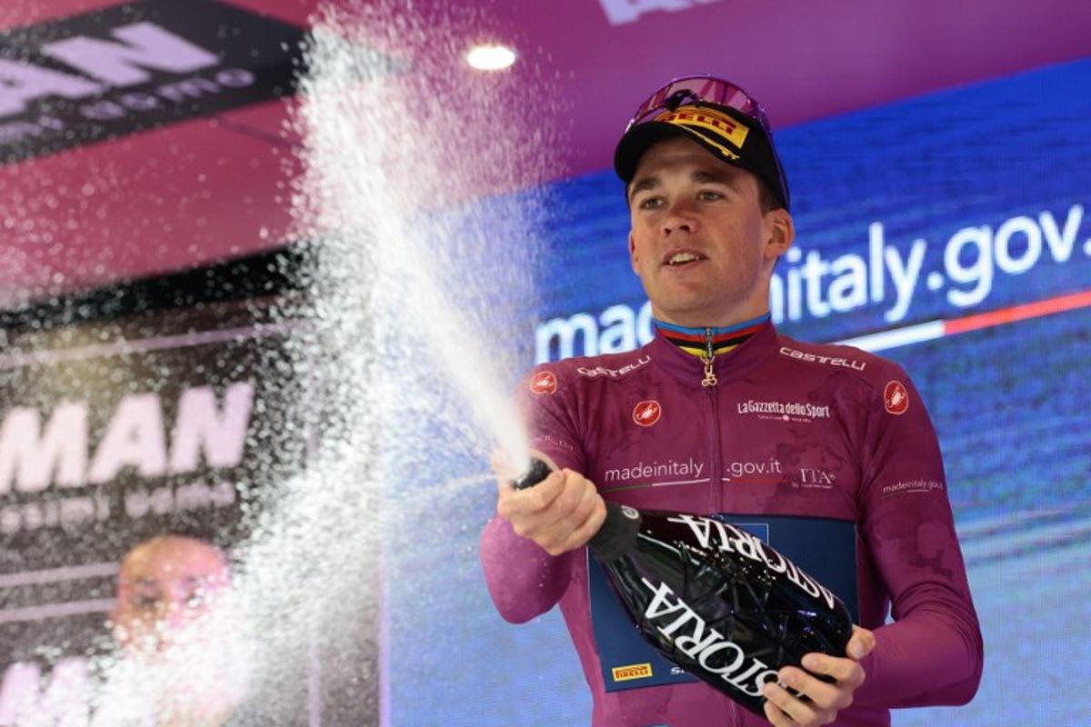 Lidl-Trek's Danish rider Mads Pedersen celebrates the Cyclamen Jersey on the podium of the 12th stage of the 108th Giro d'Italia cycling race of 172kms from Modena to Viadana on May 22, 2025.  Luca Bettini / AFP