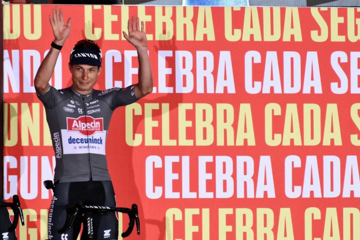 Team Alpecin's Belgian rider Jasper Philipsen waves during the official teams presentation of the 80th edition of 'La Vuelta' cycling tour of Spain, in Torino, Italy on August 21, 2025.  Marco BERTORELLO / AFP