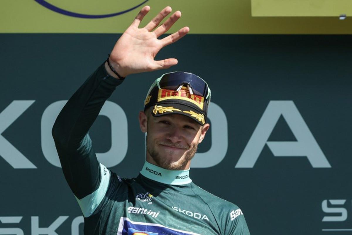 Lidl - Trek team's Italian rider Jonathan Milan celebrates on the podium with the best sprinter's green jersey after the 8th stage of the 112th edition of the Tour de France cycling race, 171.4 km between Saint-Meen-le-Grand and Laval Espace Mayenne, western France, on July 12, 2025.  Anne-Christine POUJOULAT / AFP