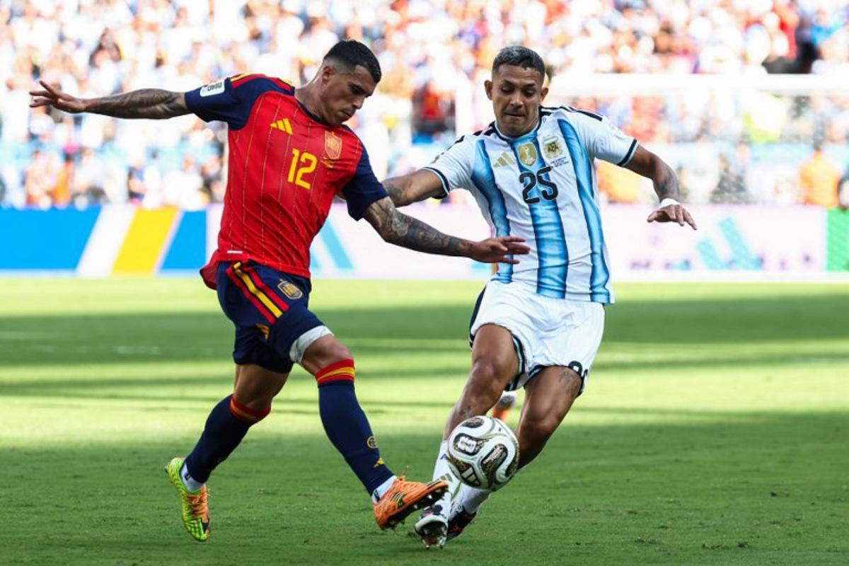 Spain's defender #12 Pedro Porro and Argentina's defender #25 Facundo Medina fight for the ball during the 2026 World Cup football tournament final match between Spain and Argentina at the New York/New Jersey Stadium in East Rutherford on July 19, 2026.   FRANCK FIFE / AFP