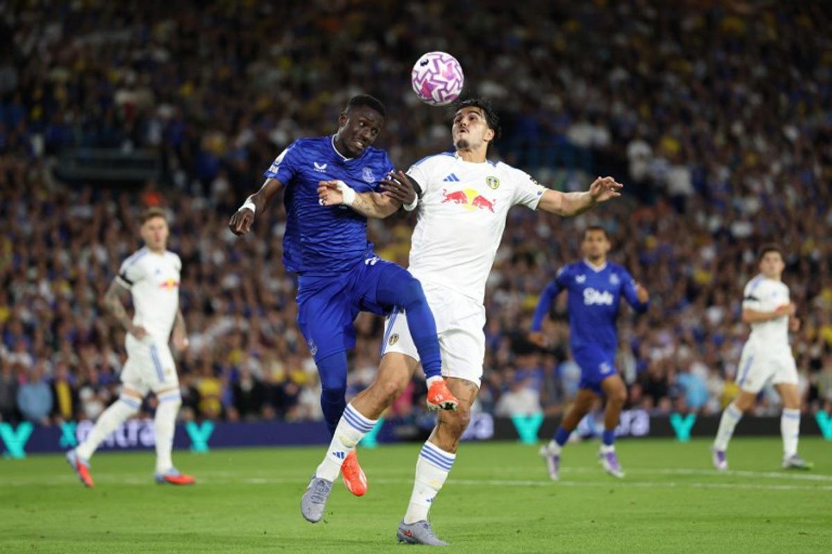Everton's Senegalese midfielder #27 Idrissa Gueye (L) vies with Leeds United's Dutch defender #05 Pascal Struijk (R) during the English Premier League football match between Leeds United and Everton at Elland Road in Leeds, northern England on August 18, 2025.  Darren Staples / AFP