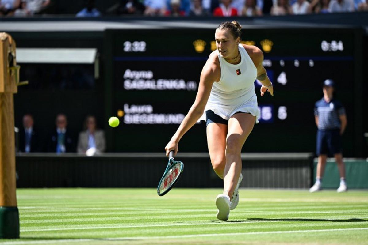 Belarus's Aryna Sabalenka returns the ball to Germany's Laura Siegemund during their women's singles quarter-final tennis match on the ninth day of the 2025 Wimbledon Championships at The All England Lawn Tennis and Croquet Club in Wimbledon, southwest London, on July 8, 2025.  Kirill KUDRYAVTSEV / AFP