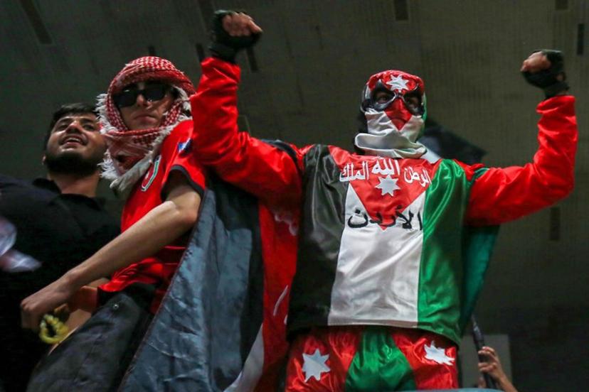 Jordan's fans cheer as they watch the 2026 FIFA World Cup Asian Qualifier football match between Jordan and Oman on big screens at the Prince Hamza hall in the Sports City in Amman on June 5, 2025.  Khalil MAZRAAWI / AFP
