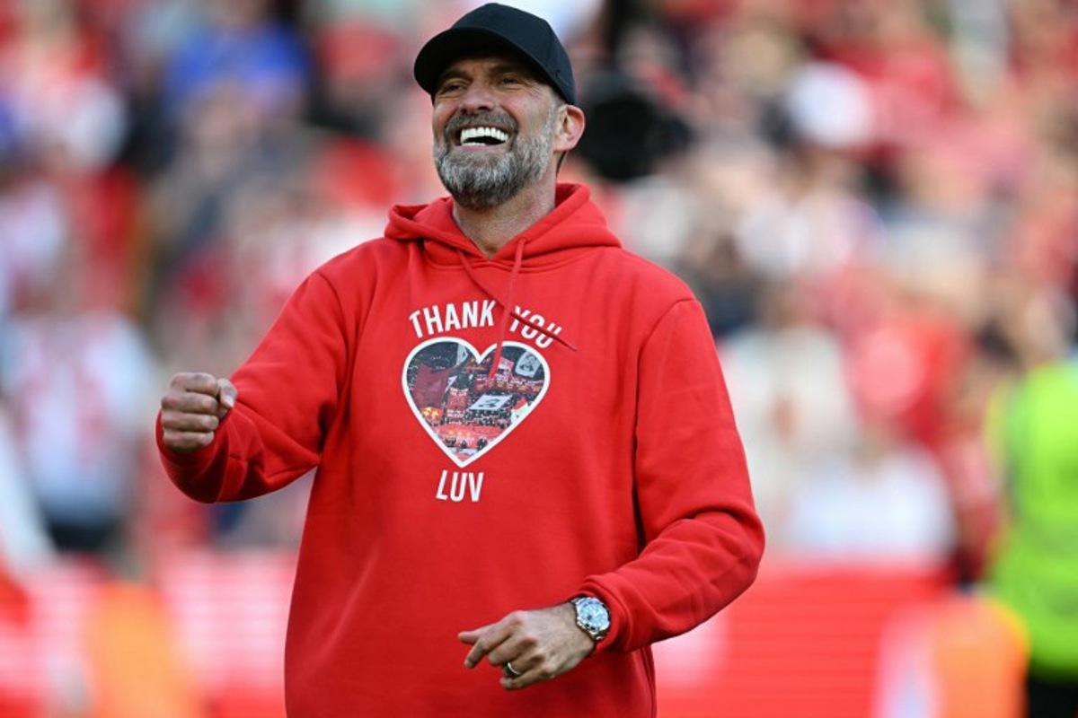 Liverpool's German manager Jurgen Klopp smiles as he makes his final farewell to fans after the English Premier League football match between Liverpool and Wolverhampton Wanderers at Anfield in Liverpool, north west England on May 19, 2024. Jurgen Klopp was given a heartfelt reception by home fans at Anfield as he walked out for his final match as Liverpool manager on Sunday. Klopp, who arrived at the club in October 2015, won seven major trophies at Liverpool, including the club's first league title for 30 years and the 2019 Champions League. Paul ELLIS / AFP