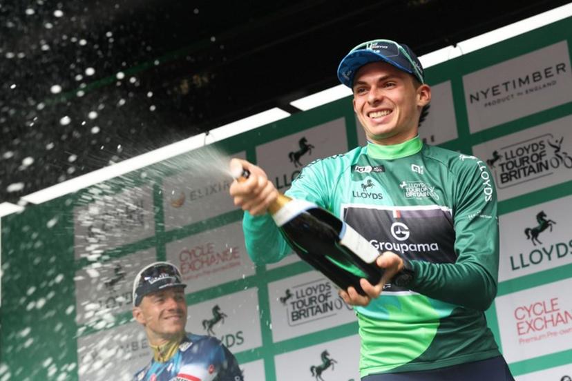 Groupama FGJ's French rider Romain Gregoire sparys the champagne as he celebrate his overall victory in the Tour of Britain cycling race, in Cardiff on September 7, 2025.  Darren Staples / AFP