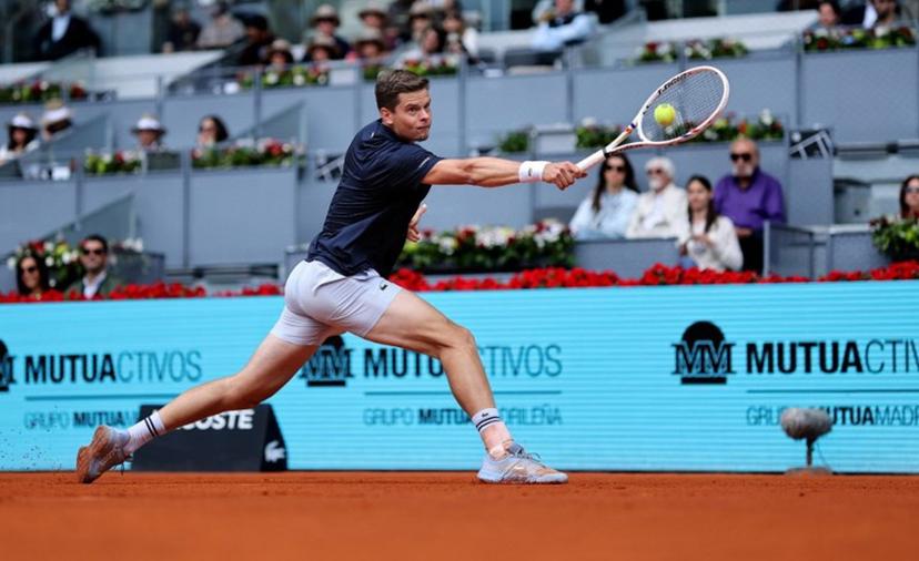 Belgium's Alexander Blockx returns the ball to Norway's Casper Ruud during their 2026 ATP Tour Madrid Open tennis tournament quarter-final singles match at the Caja Magica in Madrid, on April 30, 2026.  Thomas COEX / AFP