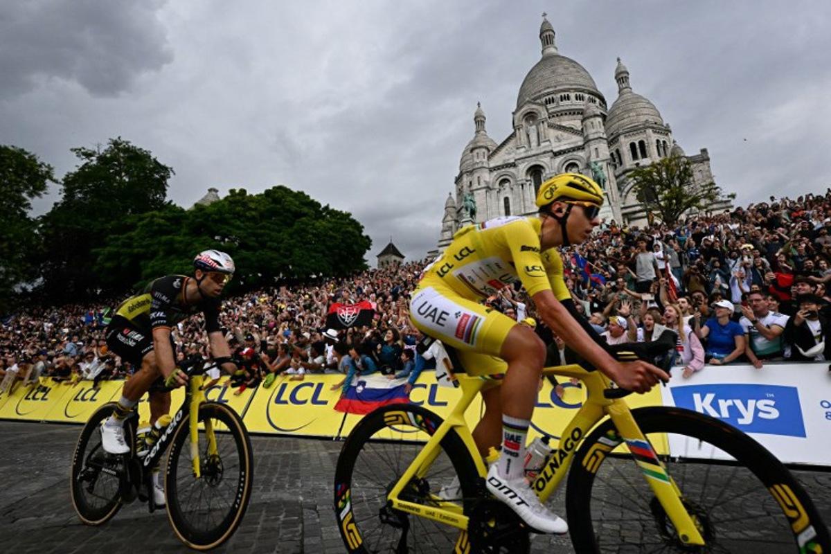 UAE Team Emirates - XRG team's Slovenian rider Tadej Pogacar wearing the overall leader's yellow jersey and Team Visma - Lease a bike team's Belgian rider Wout van Aert cycle past the Sacre-Coeur Basilica on the Butte de Montmartre during the 21st and final stage of the 112th edition of the Tour de France cycling race, 132.3 km between Mantes-la-Ville and Paris' Champs-Elysees Avenue, on July 27, 2025.  Loic VENANCE / AFP
