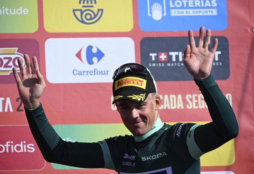 Team Lidl-Trek's Danish rider Mads Pedersen wearing the points ranking leader's green jersey celebrates on the podium after the 13th stage of the Vuelta a Espana, a 202 km race between Cabezon de la Sal and L'Angliru, on September 5, 2025.    Miguel RIOPA / AFP