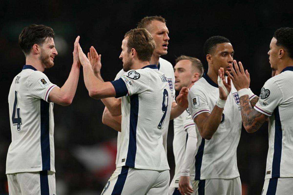 England's striker #09 Harry Kane (C) celebrates with teammates after scoring their second goal during the 2026 World Cup Group K qualifier football match between England and Albania, at Wembley stadium in London, on March 21, 2025.   Glyn KIRK / AFP