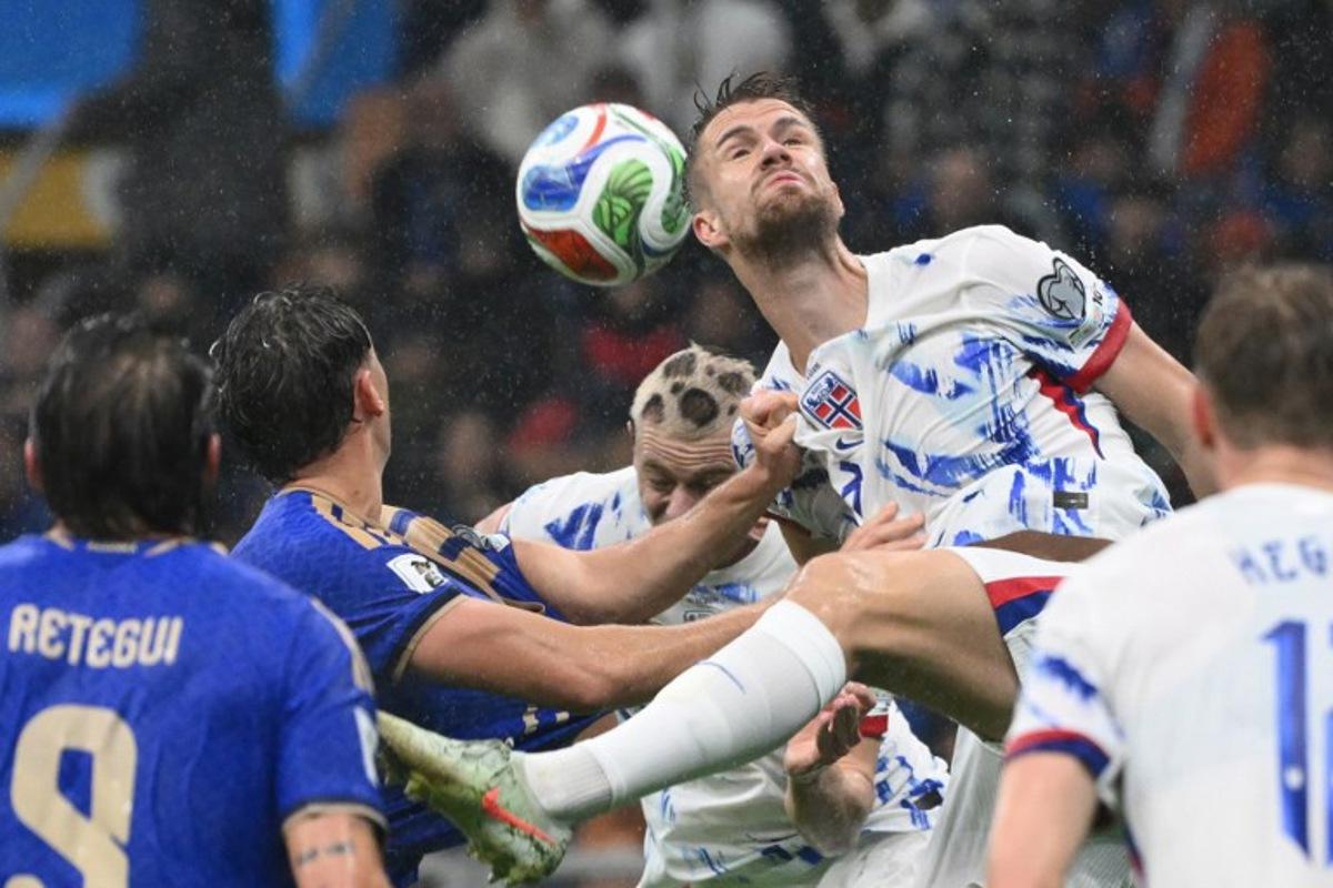 Norway's defender #03 Kristoffer Vassbakk Ajer jumps for the ball during the FIFA World Cup 2026 European qualification football match between Italy and Norway, at the San Siro Stadium, in Milan, on November 16, 2025.     Alberto PIZZOLI / AFP