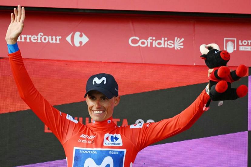 Team Movistar's Spanish rider Enric Mas celebrates on the podium retaining the overall ranking leader's red jersey after the 12th stage of the Vuelta a Espana 2026 cycling tour, a 166,6 km race between Vera and Calar Alto, on September 3, 2026.   JOSE JORDAN / AFP