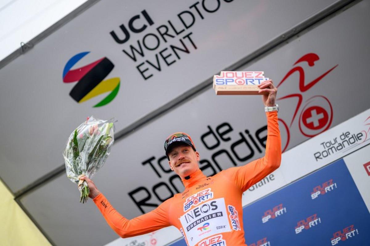INEOS Grenadiers' French rider Dorian Godon celebrates on the podium after winning the prologue of the Tour of Romandie UCI cycling World tour, a 3.2 km time trial from Villars-sur-Glane to Villars-sur-Glane on April 28, 2026.  Fabrice COFFRINI / AFP