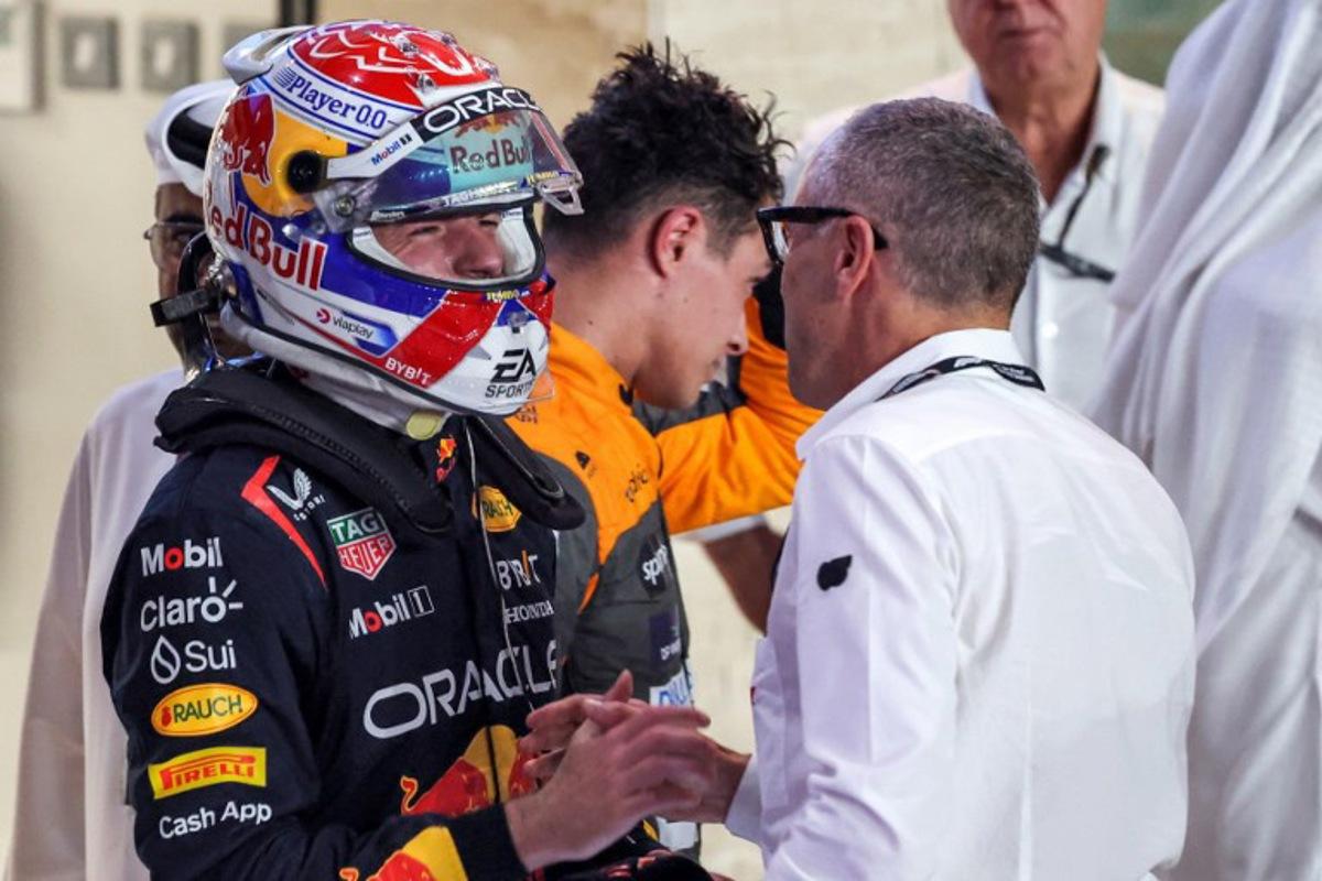 Red Bull Racing's Dutch driver Max Verstappen (L) is congratulated by Formula One CEO Stefano Domenicali (R) after the sprint race ahead of the Qatari Formula One Grand Prix at the Lusail International Circuit on October 7, 2023.  Giuseppe CACACE / AFP
