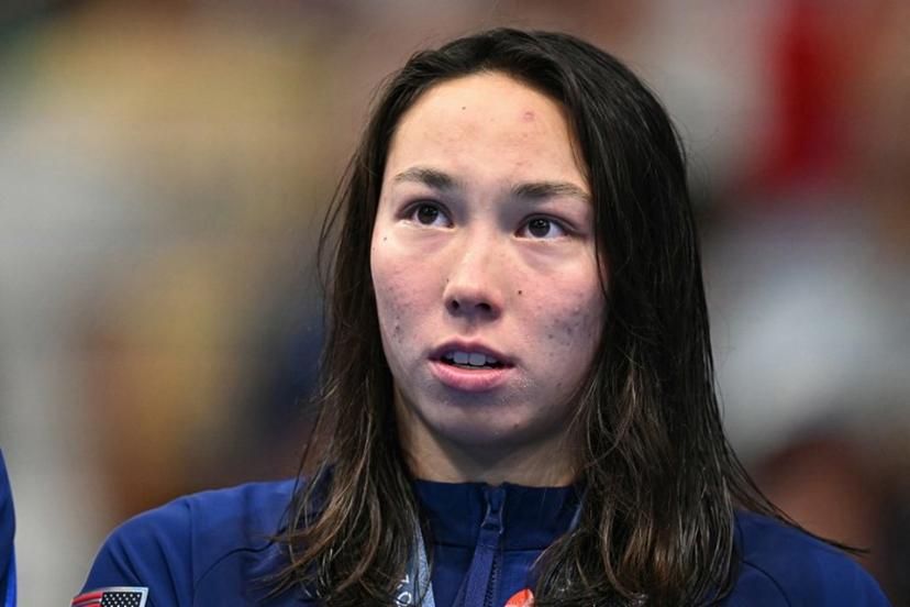 Gold medallist US' Torri Huske stands on the podium after the final of the women's 100m butterfly swimming event during the Paris 2024 Olympic Games at the Paris La Defense Arena in Nanterre, west of Paris, on July 28, 2024.   Manan VATSYAYANA / AFP