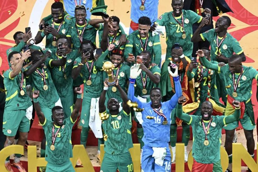 Senegal players celebrate with the trophy after winning the Africa Cup of Nations (CAN) final football match against Morocco at the Prince Moulay Abdellah Stadium in Rabat on January 18, 2026.   Paul ELLIS / AFP