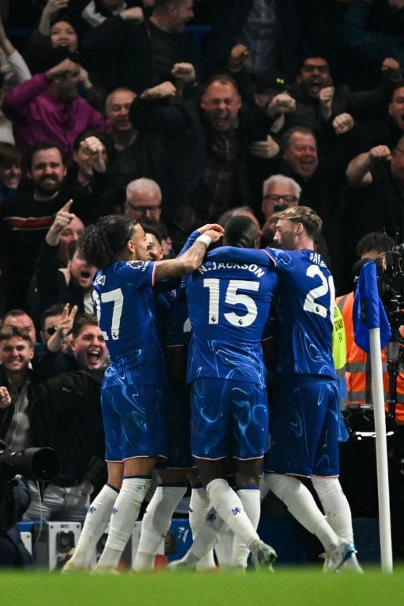 Chelsea's Ecuadorian midfielder #25 Moises Caicedo (unseen) celebrates with teammates after scoring his team second goal that will be disallowed due to a foul during the English Premier League football match between Chelsea and Tottenham Hotspur at Stamford Bridge in London on April 3, 2025.  Glyn KIRK / AFP