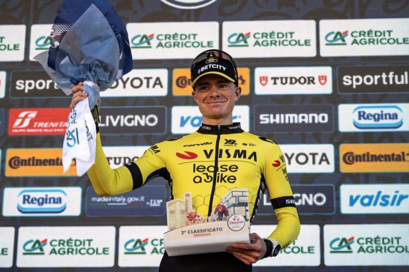 Second-placed Team Visma Lease a Bike, Britain's rider Ben Tulett (R) celebrates on the podium of the 106th edition of the one-day classic cycling race Milan - Torino between Rho, west of Milan, and Superga, east of Torino, on March 19, 2025.  MARCO BERTORELLO / AFP