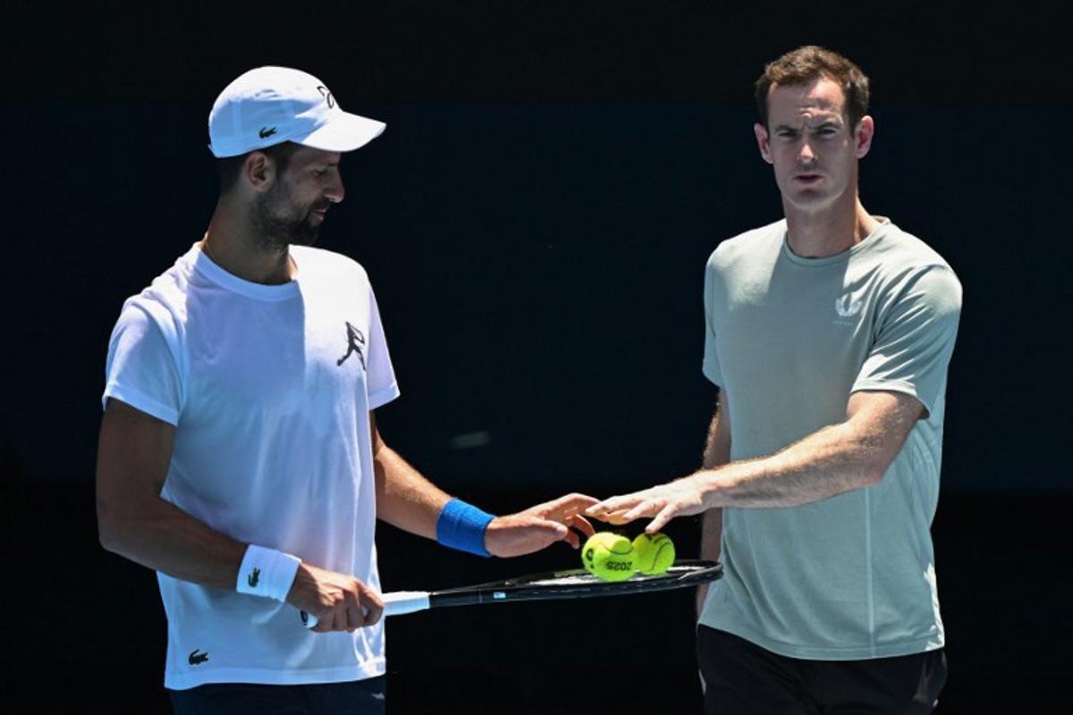 Serbia's Novak Djokovic (L) and his coach Andy Murray talk during a practice session ahead of the Australian Open tennis tournament in Melbourne on January 11, 2025.   WILLIAM WEST / AFP