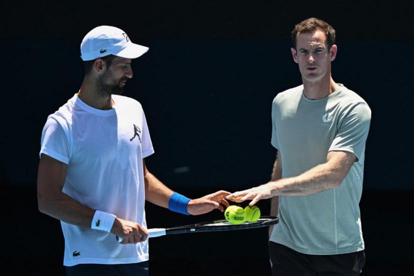 Serbia's Novak Djokovic (L) and his coach Andy Murray talk during a practice session ahead of the Australian Open tennis tournament in Melbourne on January 11, 2025.   WILLIAM WEST / AFP