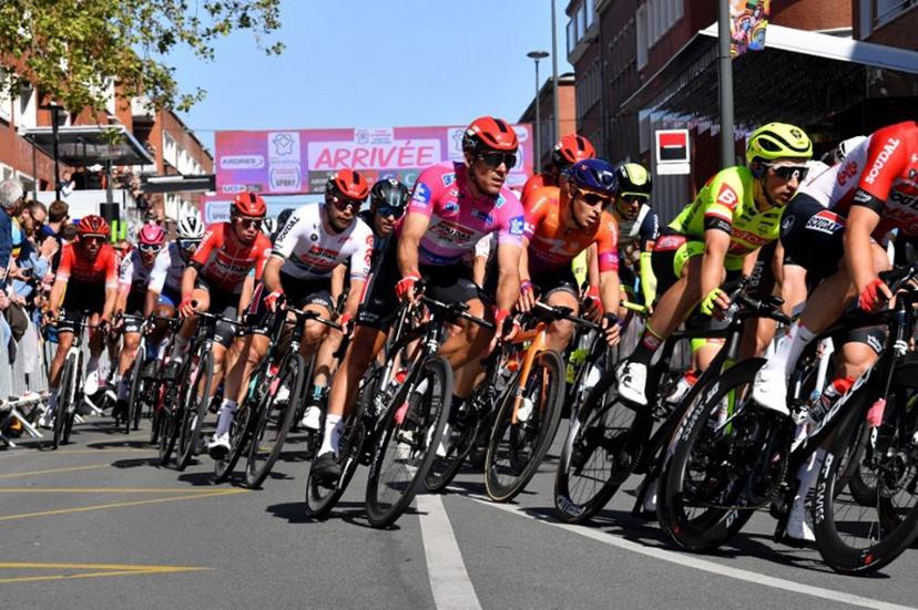 Team Lotto Soudal's Belgian rider Philippe Gilbert (C) passes the finish line in a peleton during the 6th stage of the 4 days cycling stage race of Dunkirk, on May 8, 2022 between Ardres and Dunkerque.   FRANCOIS LO PRESTI / AFP