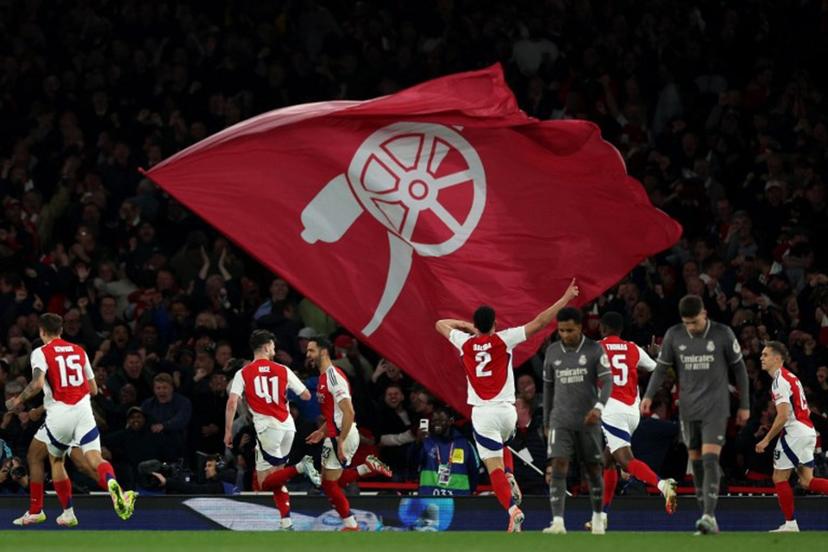 Arsenal's Spanish midfielder #23 Mikel Merino (centre right) celebrates scoring the team's third goal during the UEFA Champions League Quarter final first leg football match between Arsenal and Real Madrid, at the Emirates Stadium, in London, on April 8, 2025.   Adrian Dennis / AFP