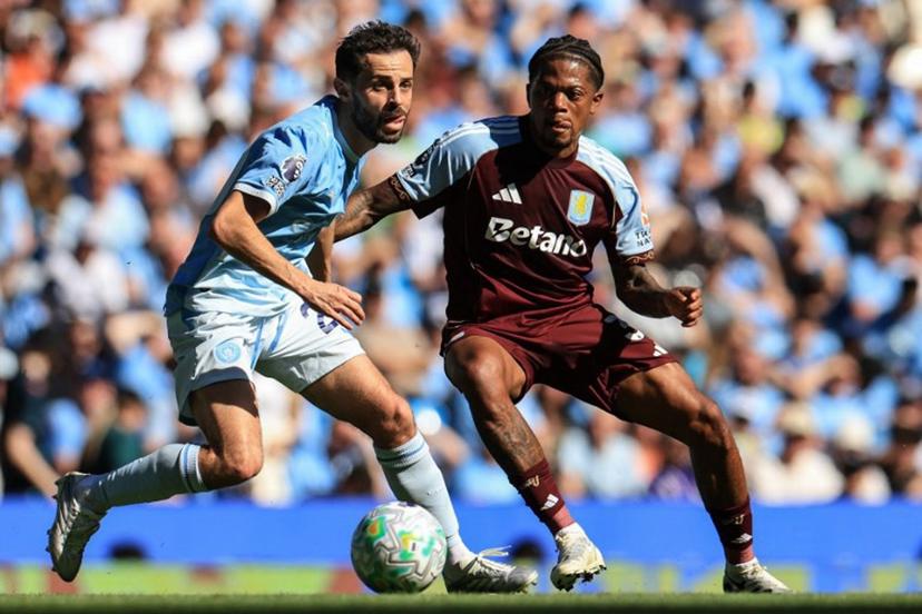 Aston Villa's Jamaican midfielder #31 Leon Bailey (R) challenges Manchester City's Portuguese midfielder #20 Bernardo Silva (L) during the English Premier League football match between Manchester City and Aston Villa at the Etihad Stadium in Manchester, north west England, on May 24, 2026.  Darren Staples / AFP